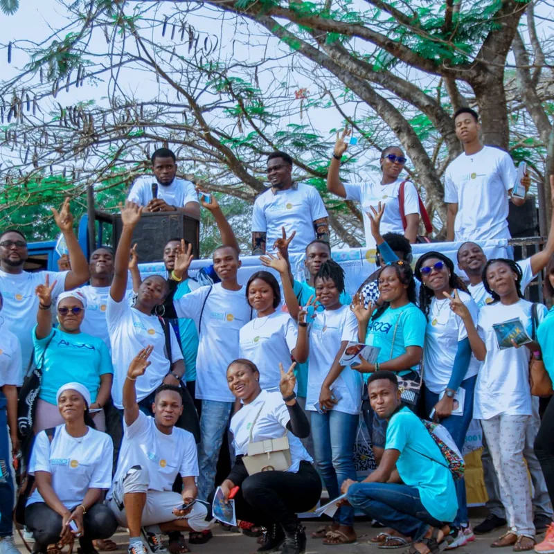 A cheerful group of ZeroDepression volunteers waving and smiling together outdoors